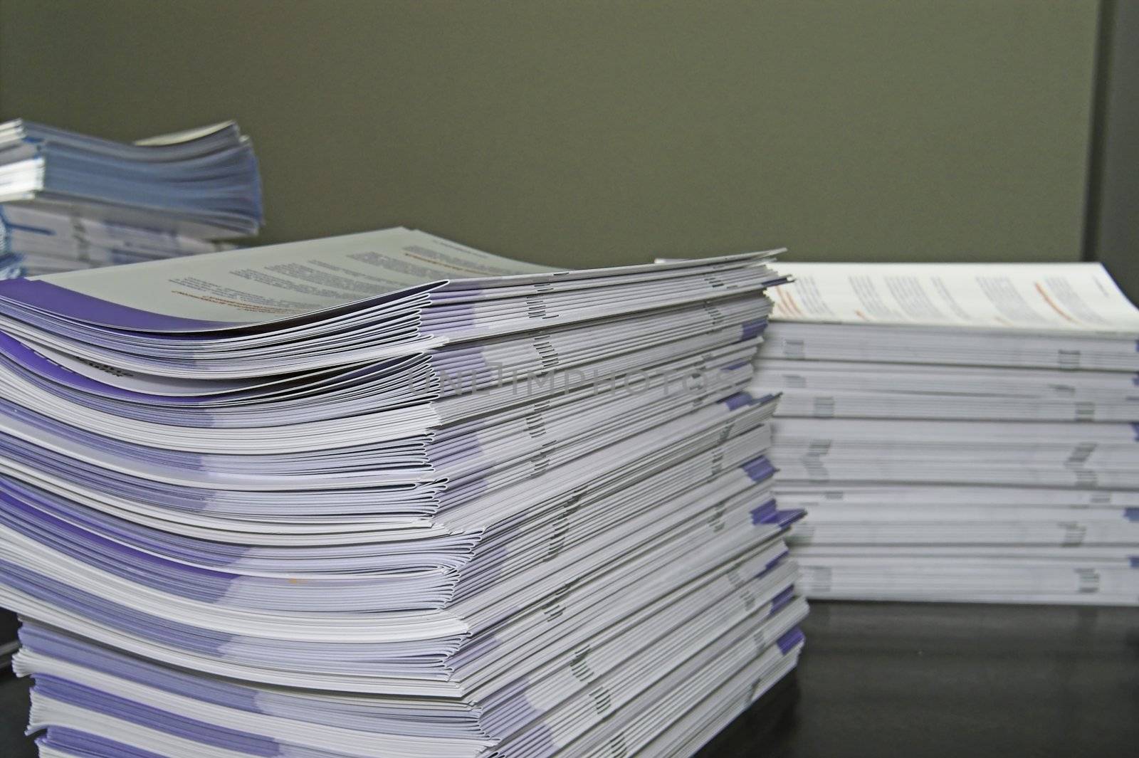 Piles of handout papers lying on a table.