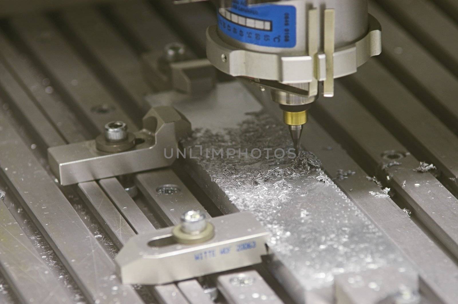 Drilling Machine automatically processing a metallic part.