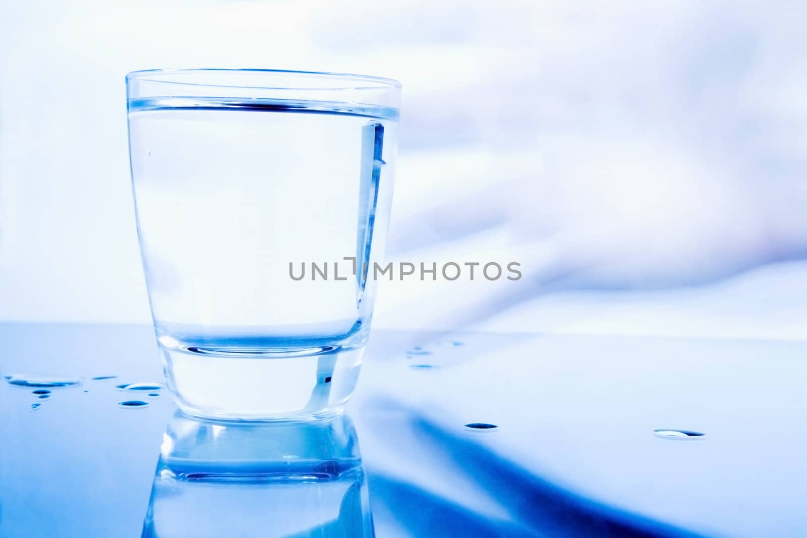 Hand grabbing a glass of water