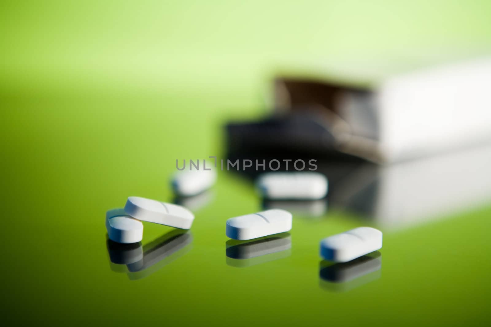 Medical tablets on a reflective glass surface