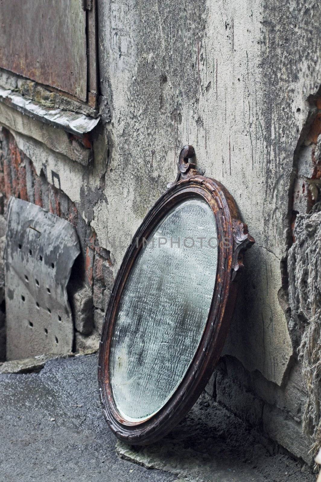 Thrown Out Old Mirror Standing Against Wall