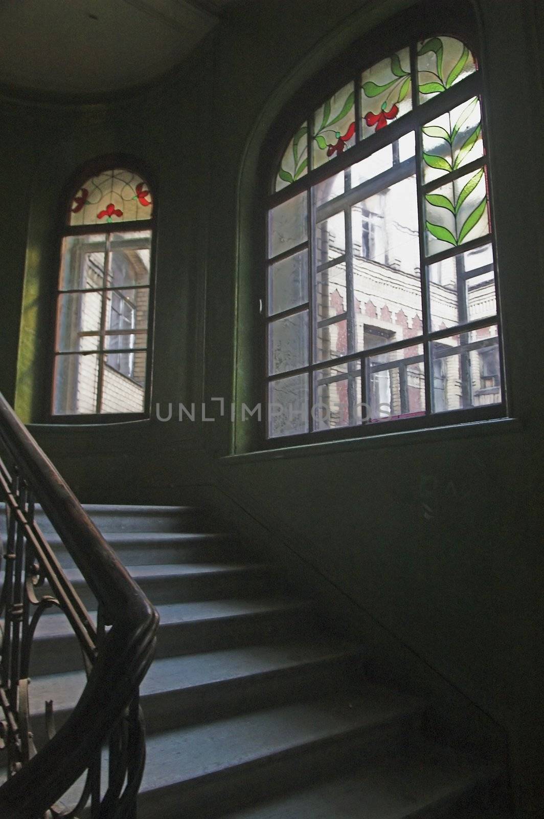 Stairway and stained-glass windows in old building