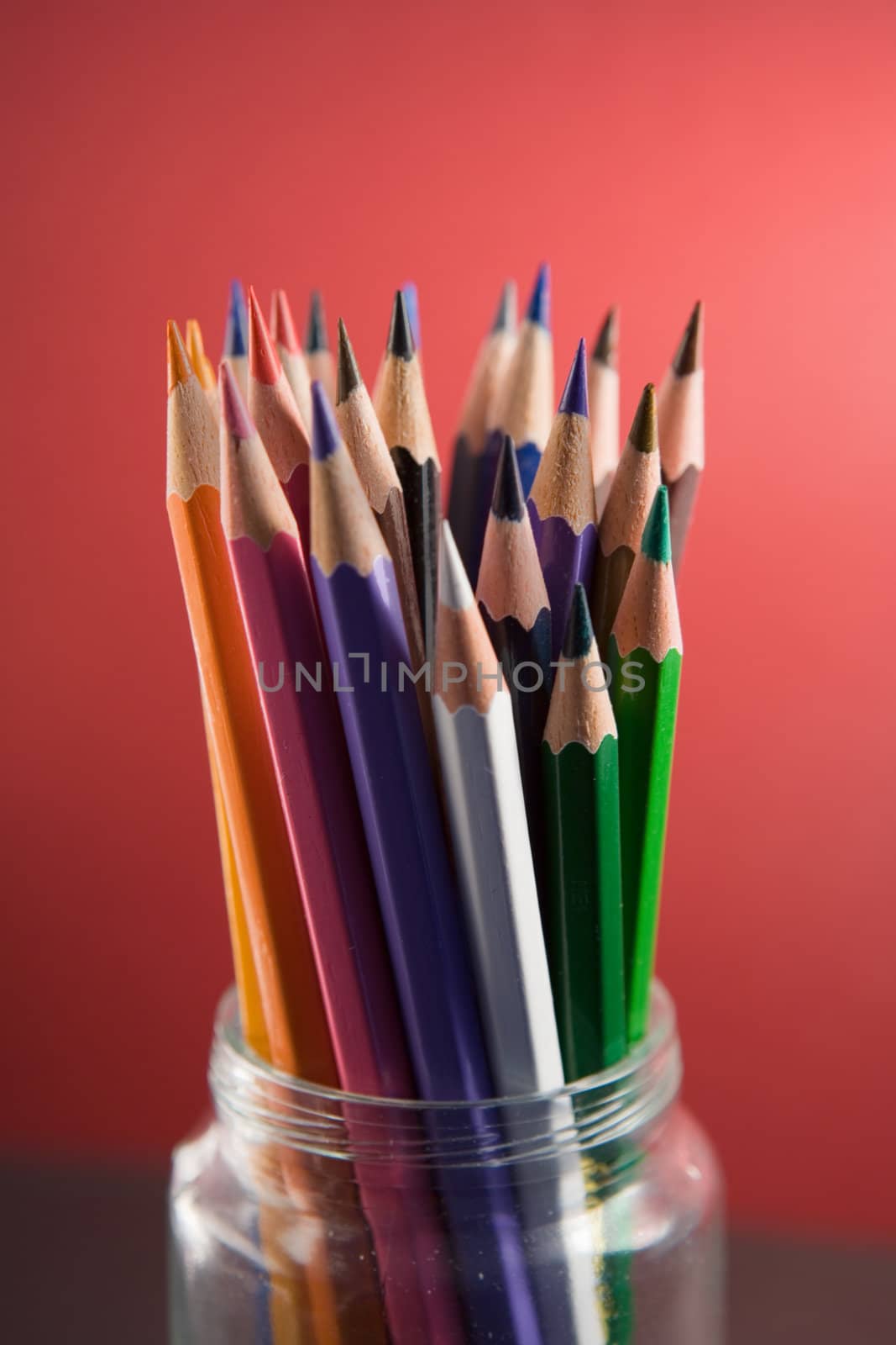 Colored pencils in a glass jar