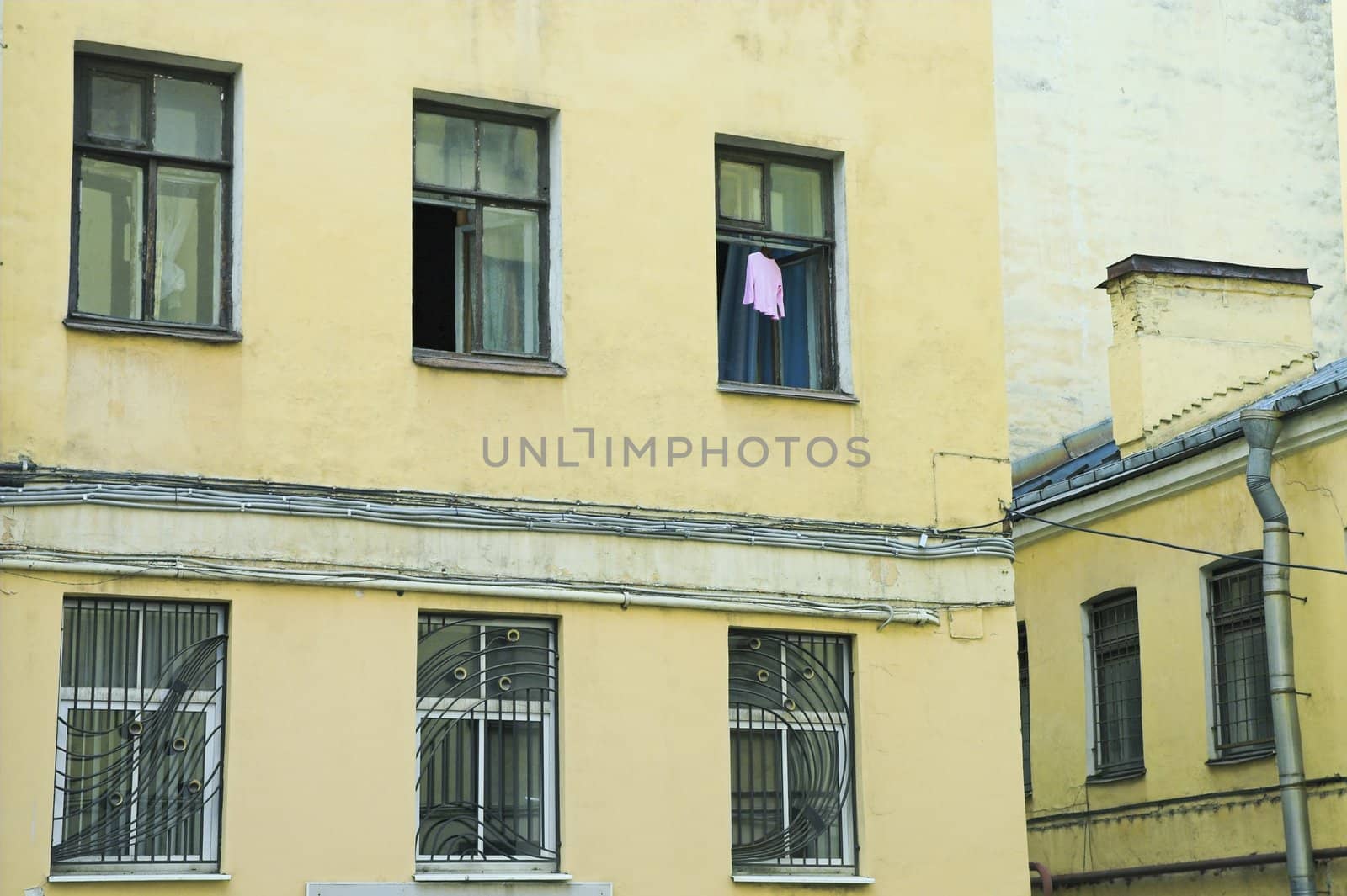 Dress hanging to dry in open window of old building