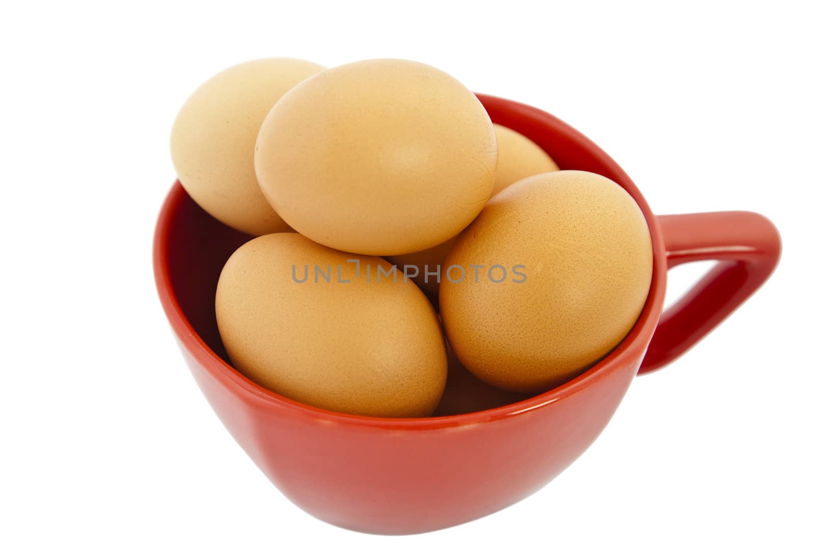 brown eggs in red bowl on white background
