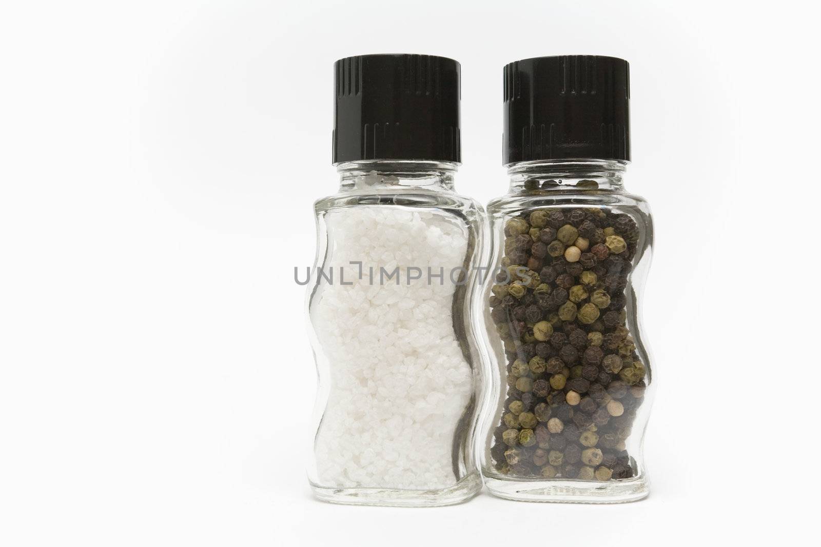 Salt and pepper grinders standing on a white background