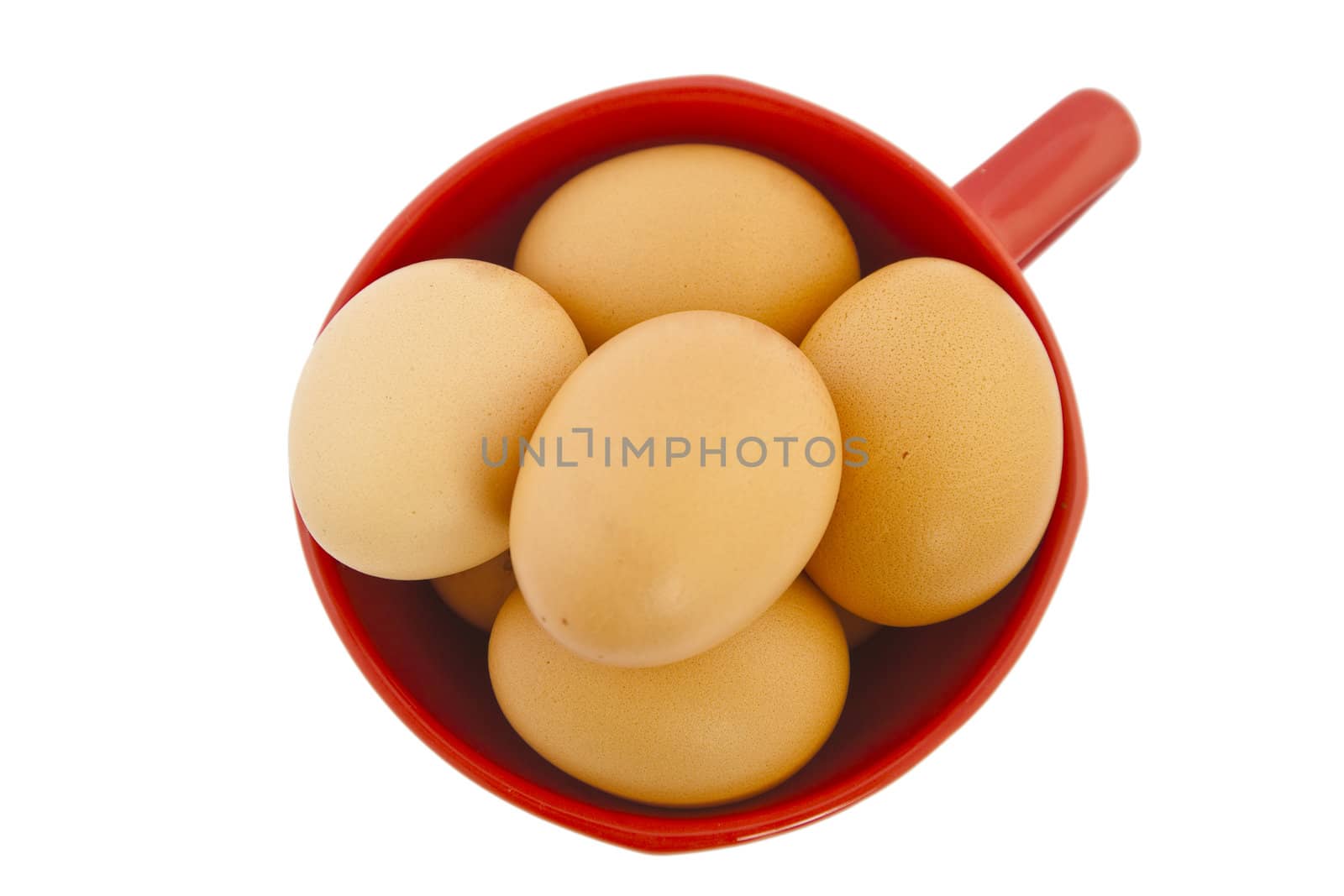 brown eggs in red bowl on white background