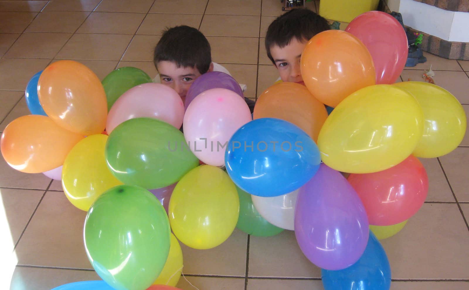 kids playing with colored ballons