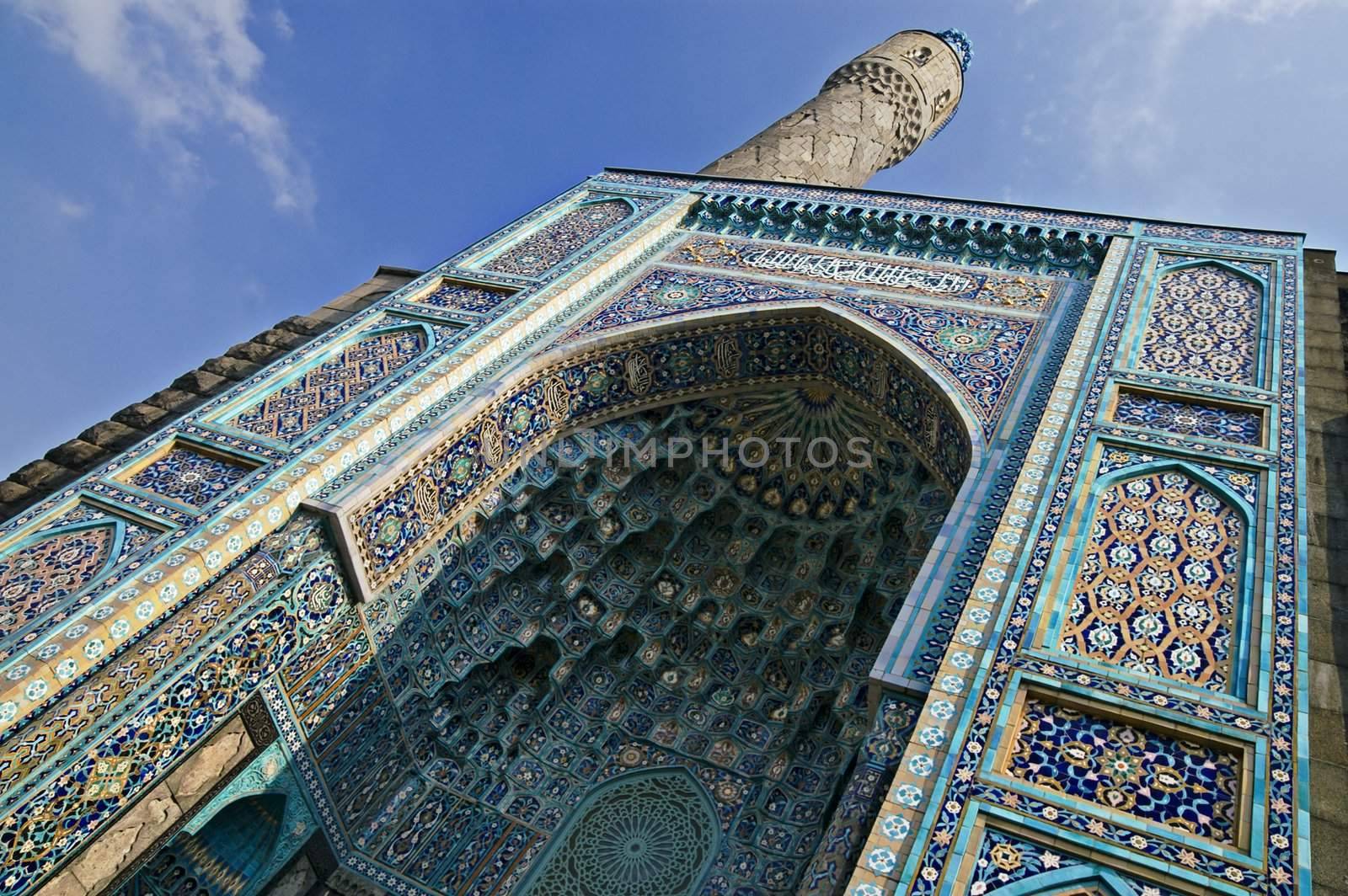 The minaret and the front wall with Arabic mosaics of the ancient mosque in Saint Petersburg, Russia.