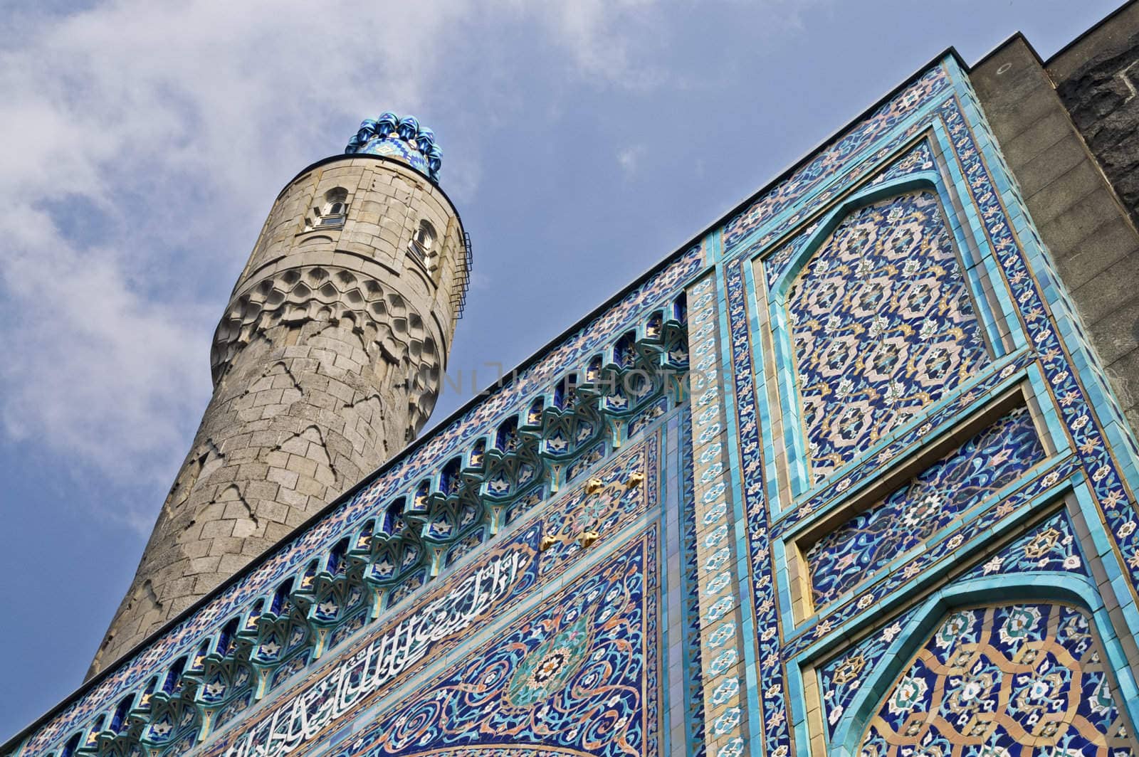 The minaret and the front wall with Arabic mosaics of the ancient mosque in Saint Petersburg, Russia.