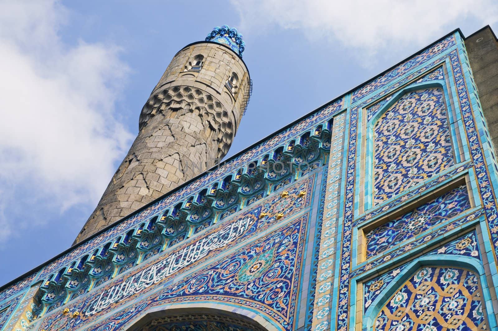 The minaret and the front wall with Arabic mosaics of the ancient mosque in Saint Petersburg, Russia.