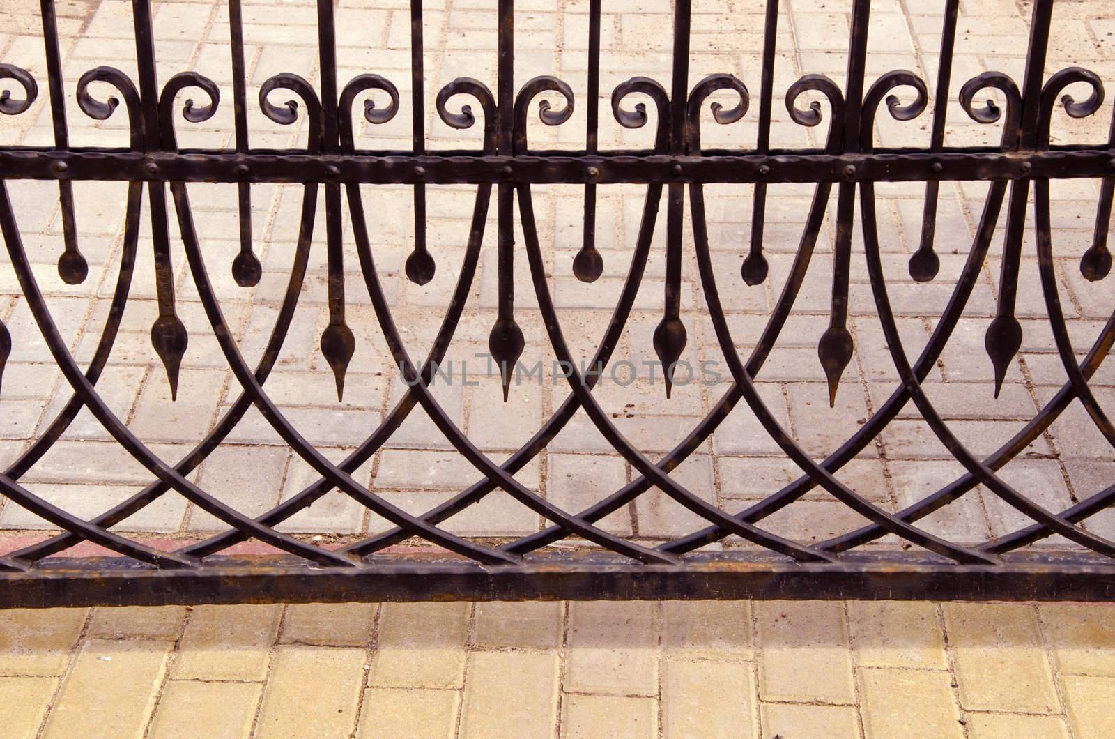 Old metal gate fragment. Beautiful forged metal ornaments.