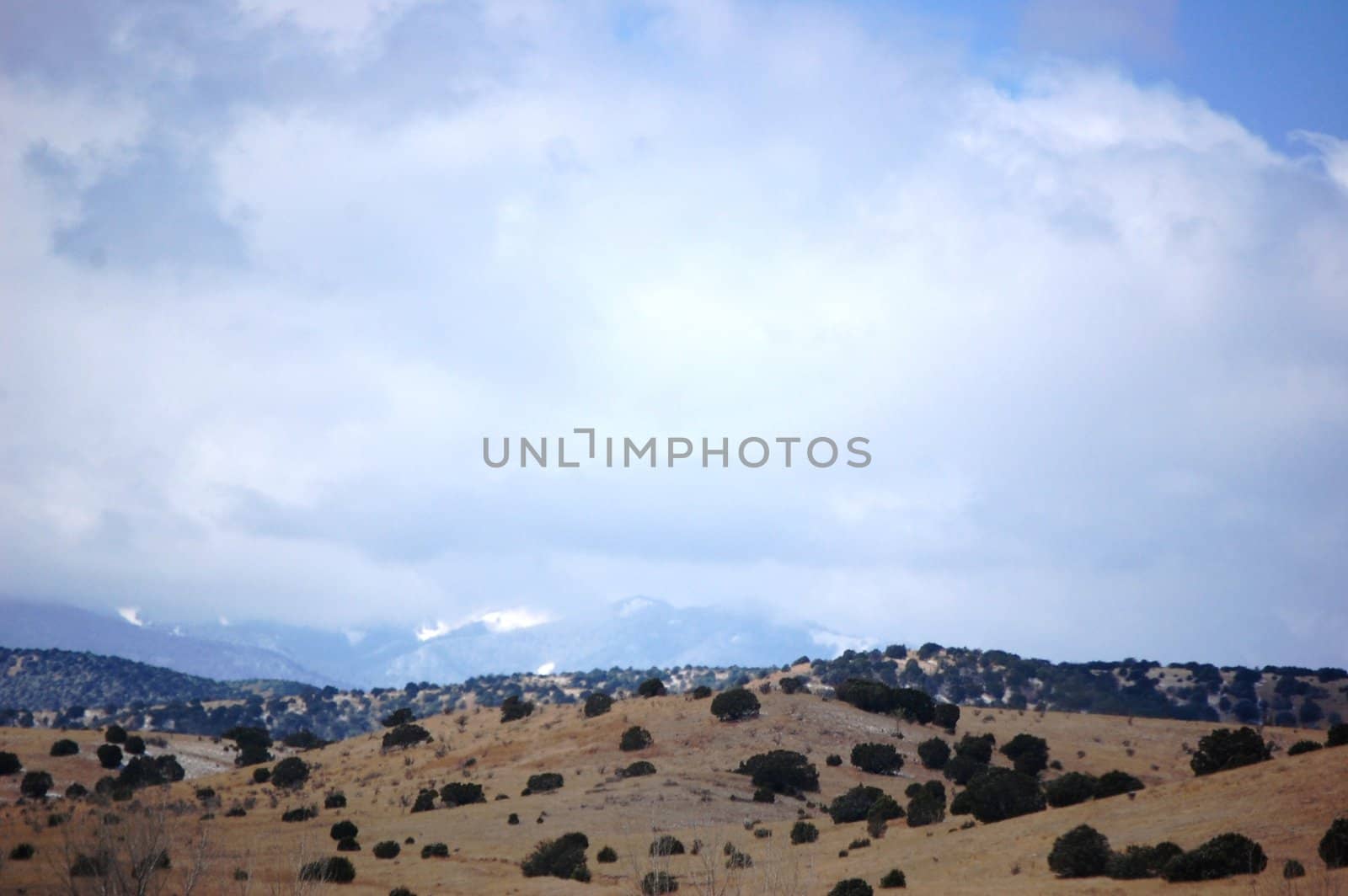 Rolling mountain hills with clouds by RefocusPhoto