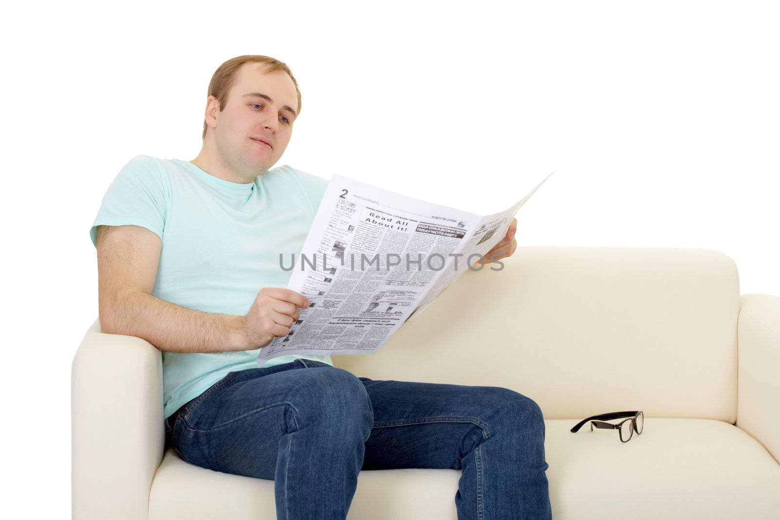 A man reads the newspaper at home