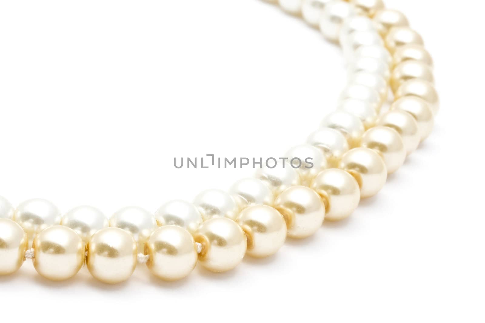 Beautiful pearl necklace closeup on white background