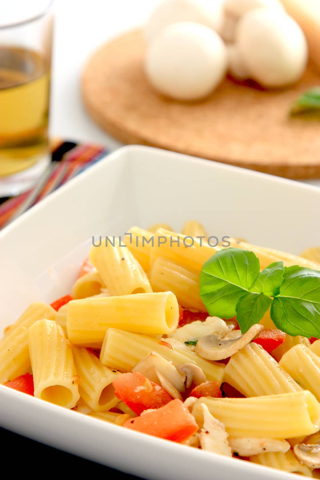 Italian pasta with tomatoes, mozzarella and mushrooms.