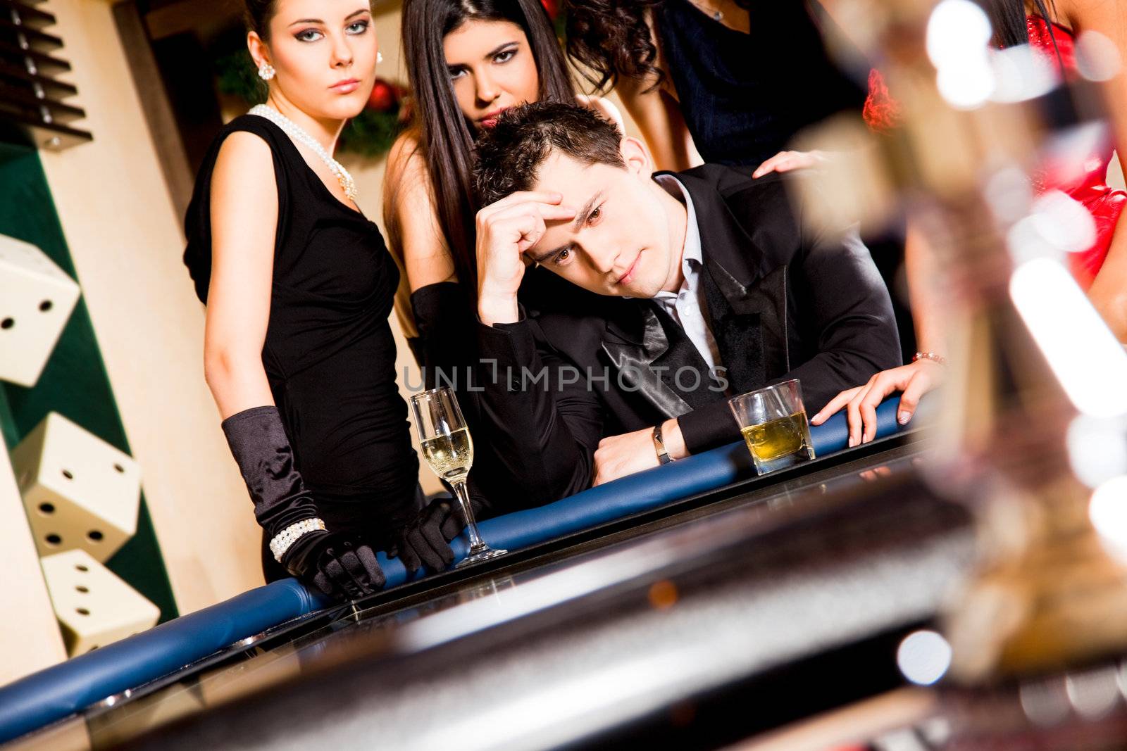 Group of young people behind roulette table