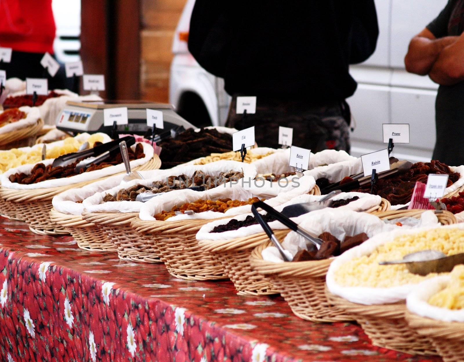 Fresh and dry fruit placed onto a table, outdoors