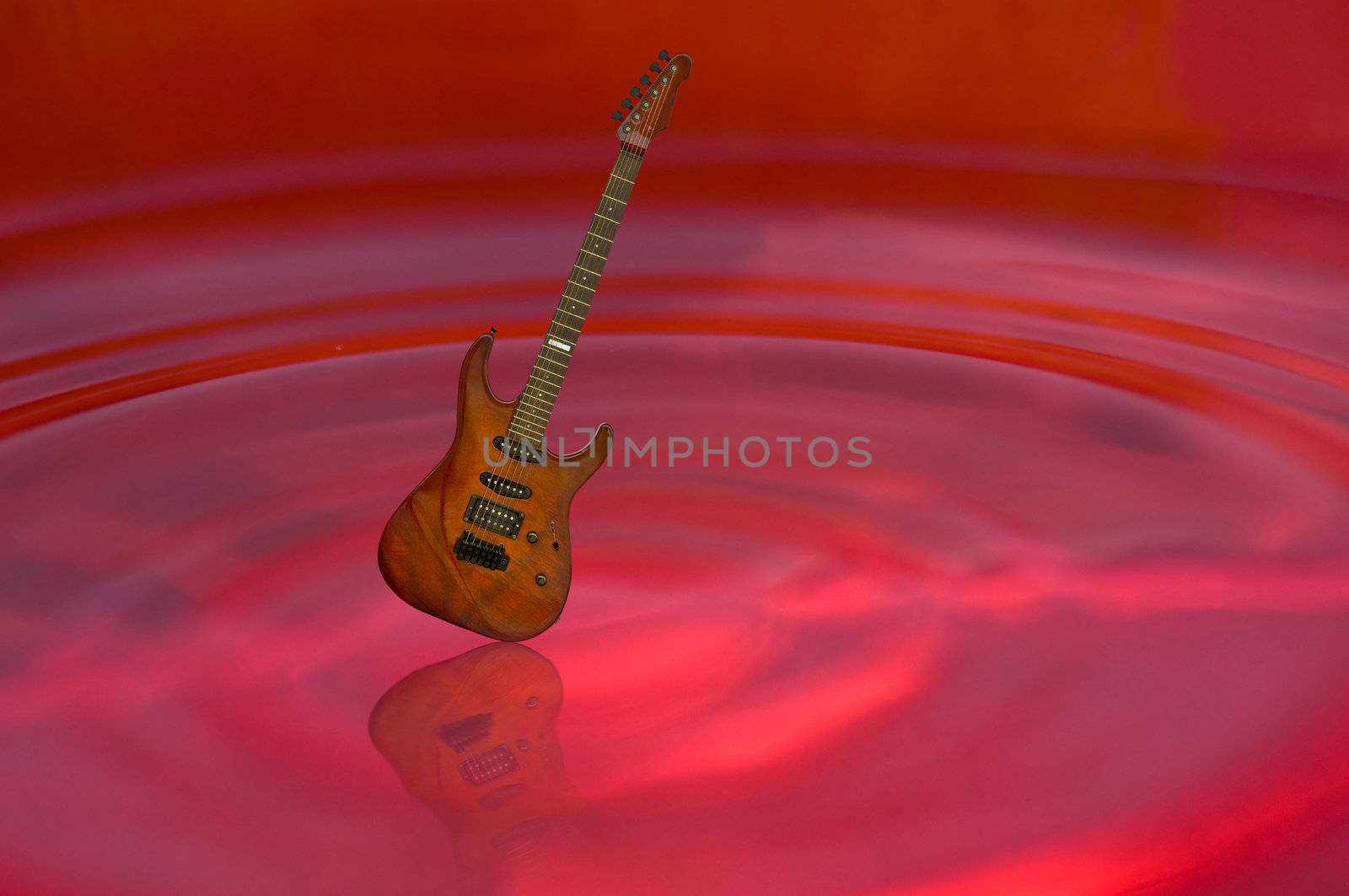 guitar and shadow on red water