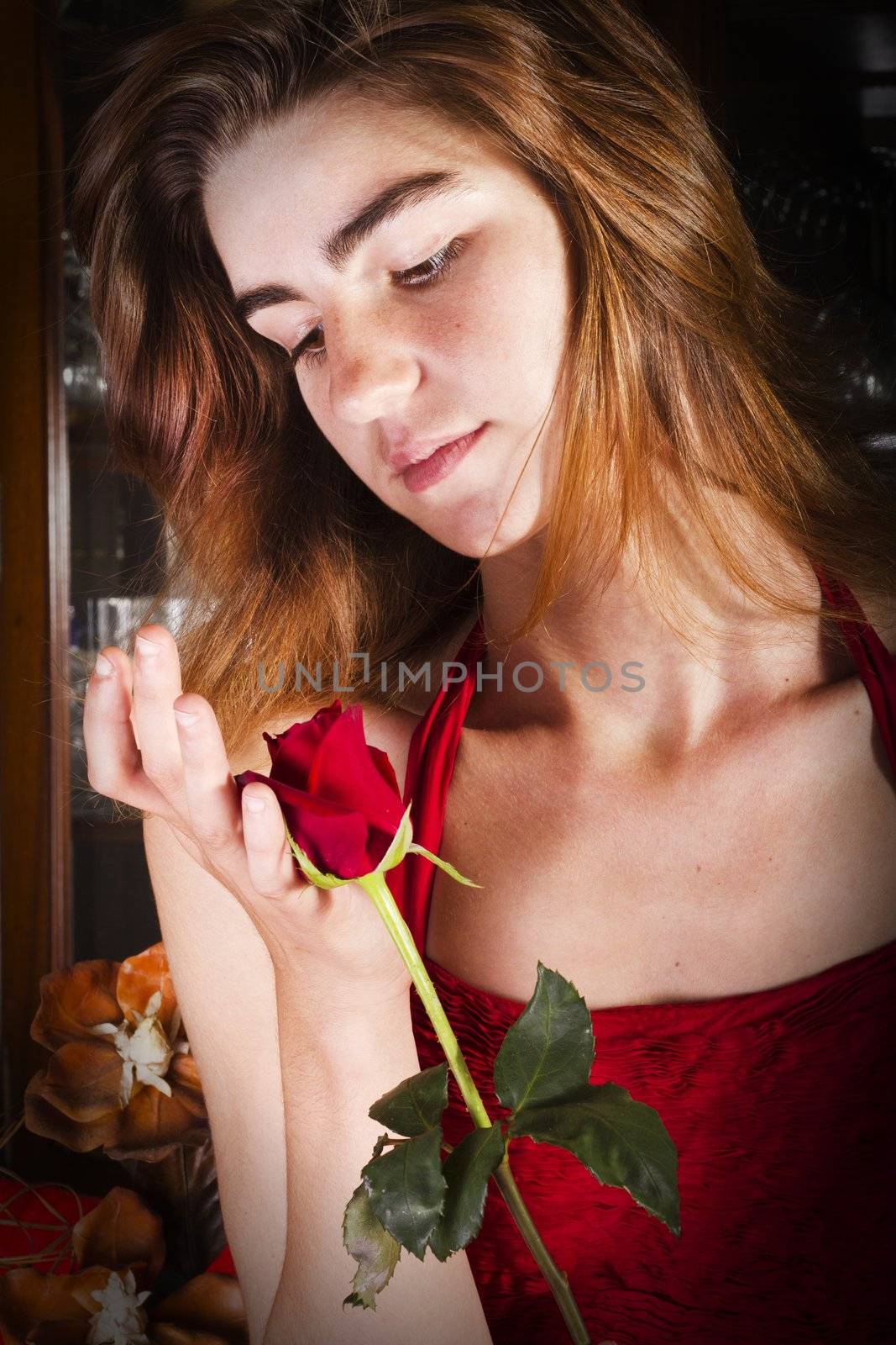 View of a beautiful young girl in a red dress on a living room.