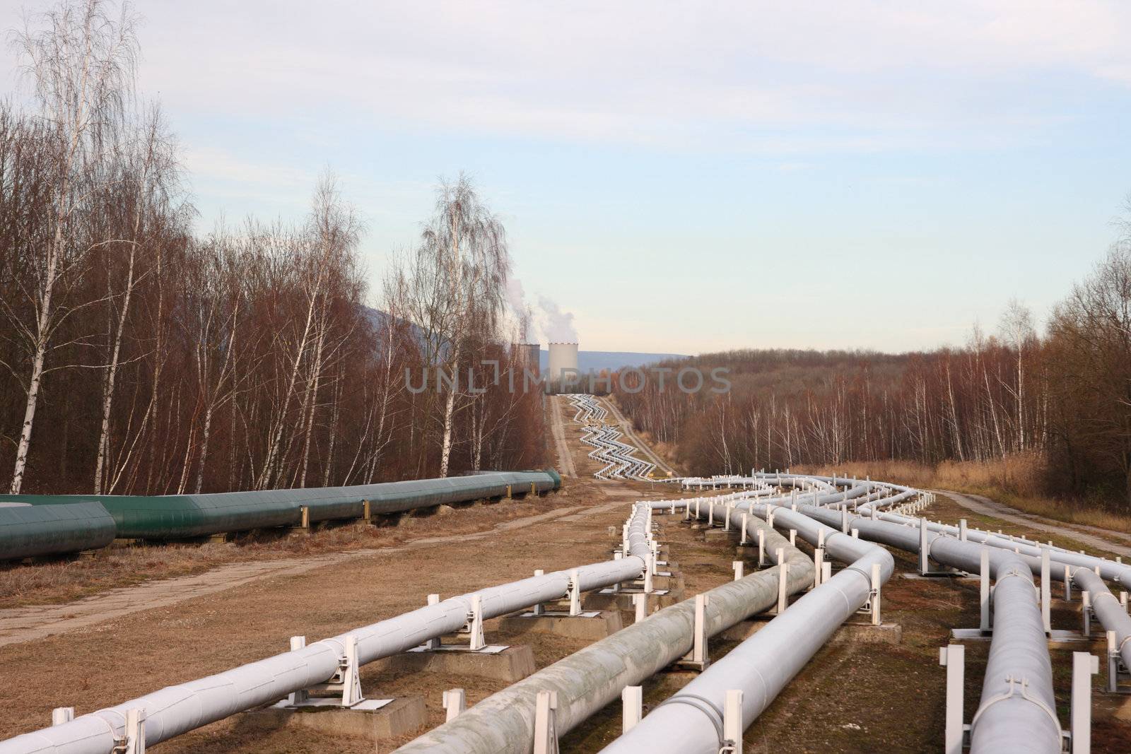 View of pipelines leading to the horizon with power-plant