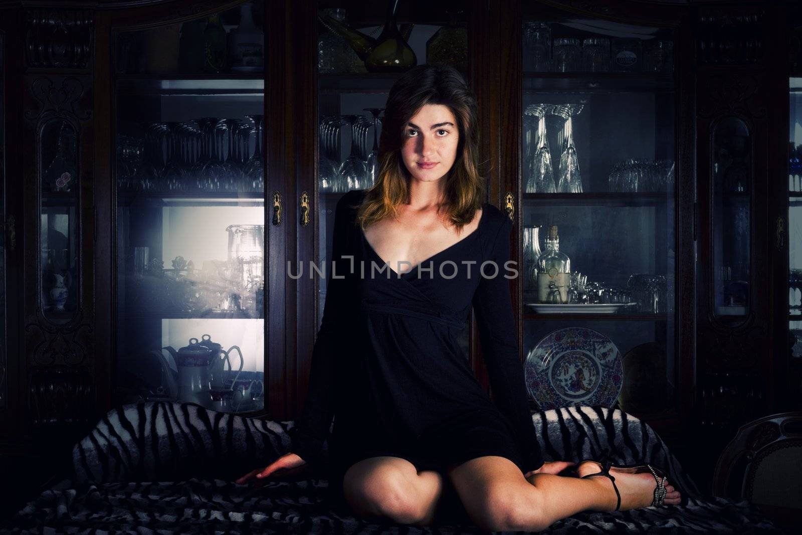 View of a beautiful young girl in a black dress on a living room.