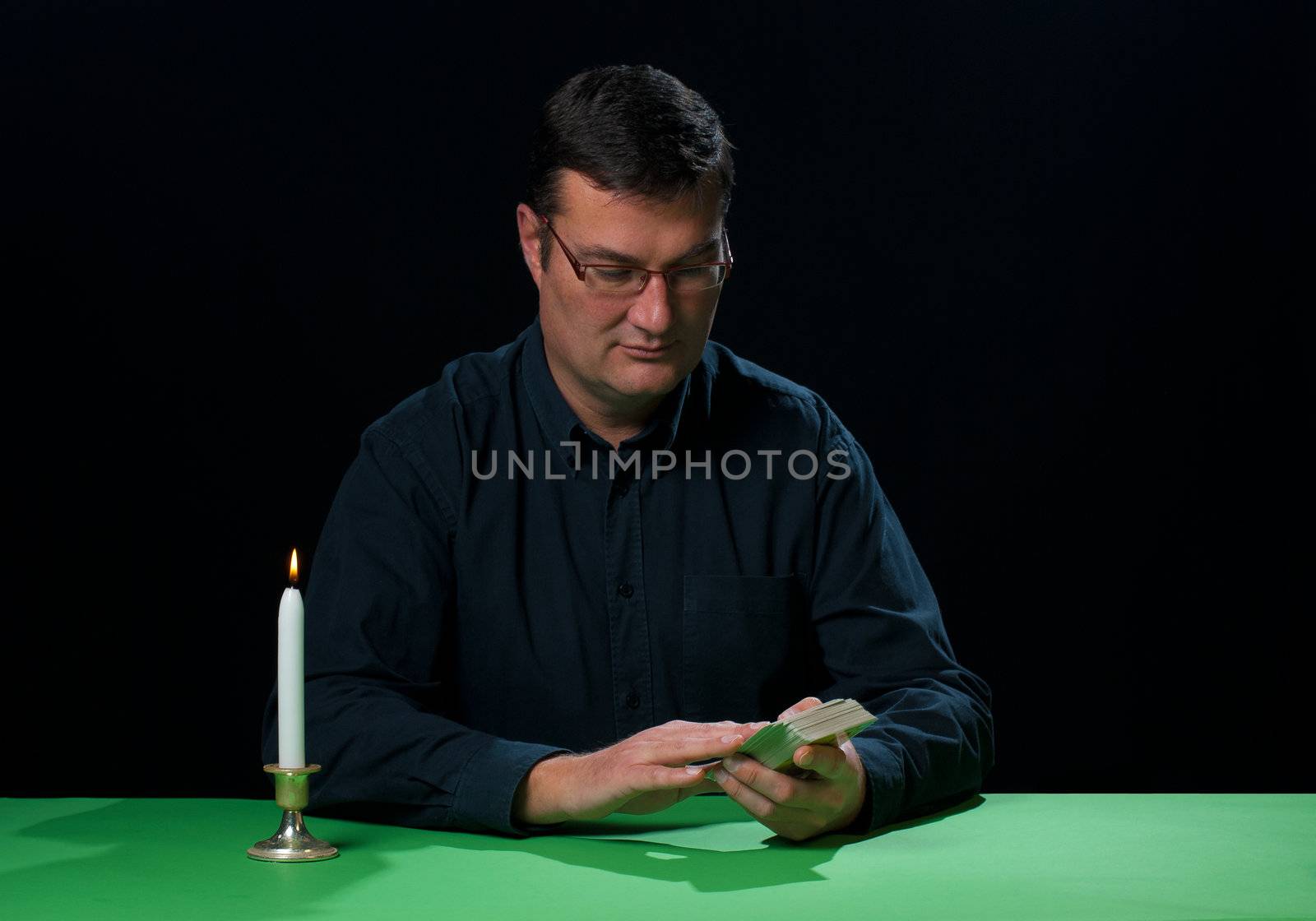 Tarot reader in full concentration about to start spreading the cards