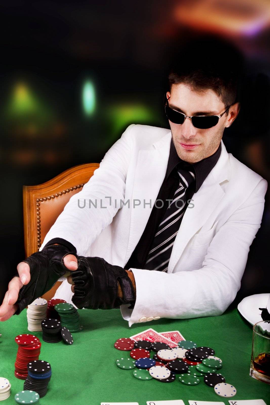 View of a gangster man playing some cards and poker.
