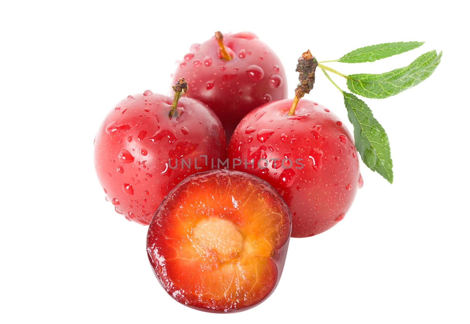 heap of wet ripe plums, isolated on white