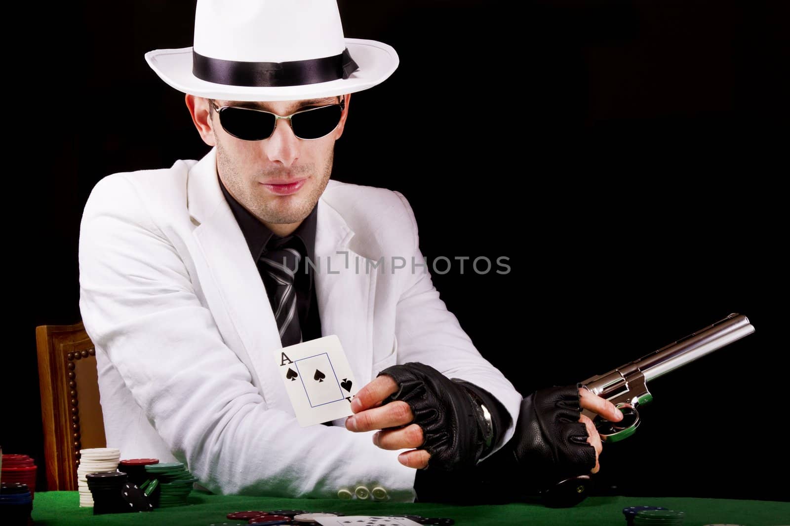 View of a white suit gangster man holding a gun.