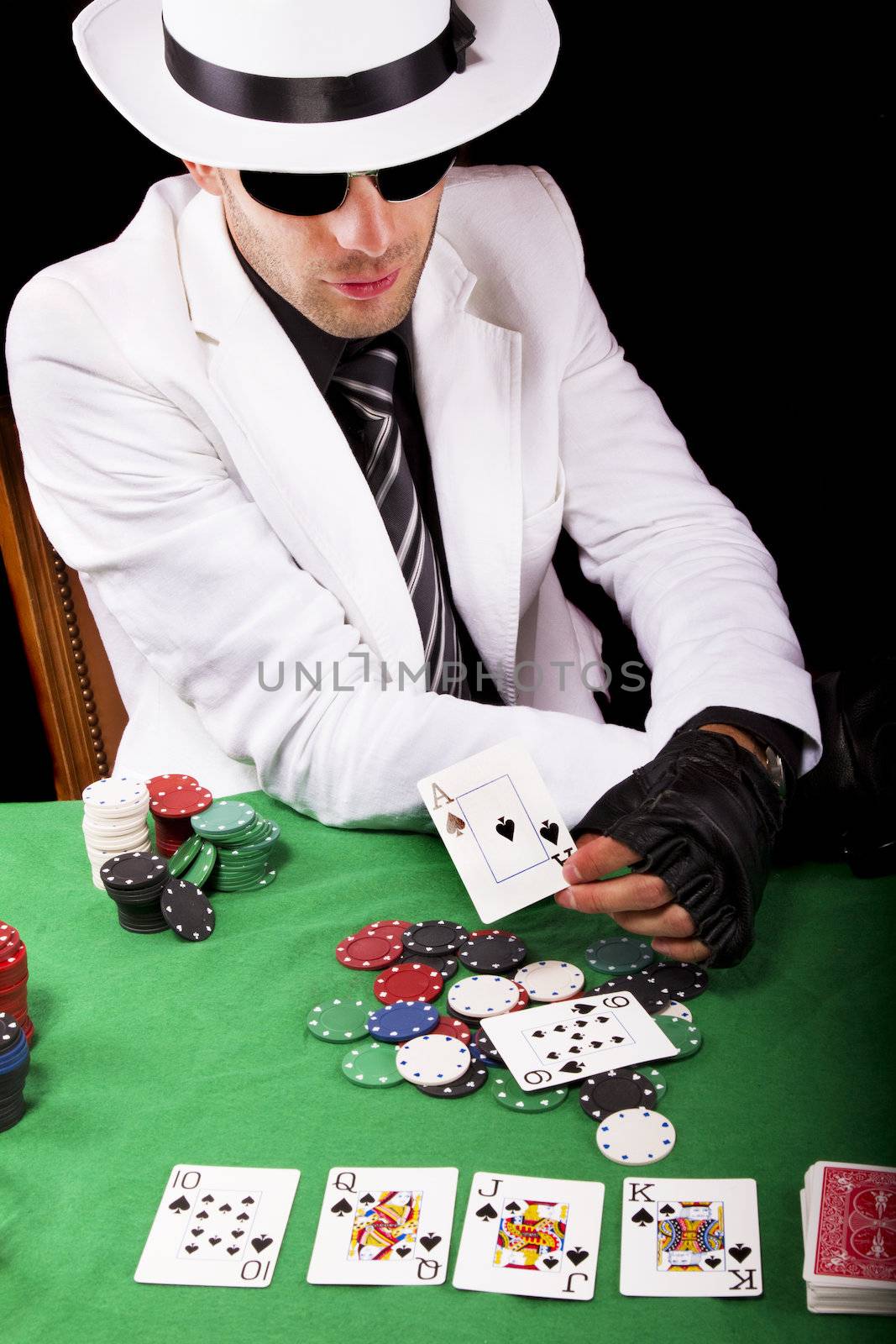 View of a gangster man playing some cards and poker.