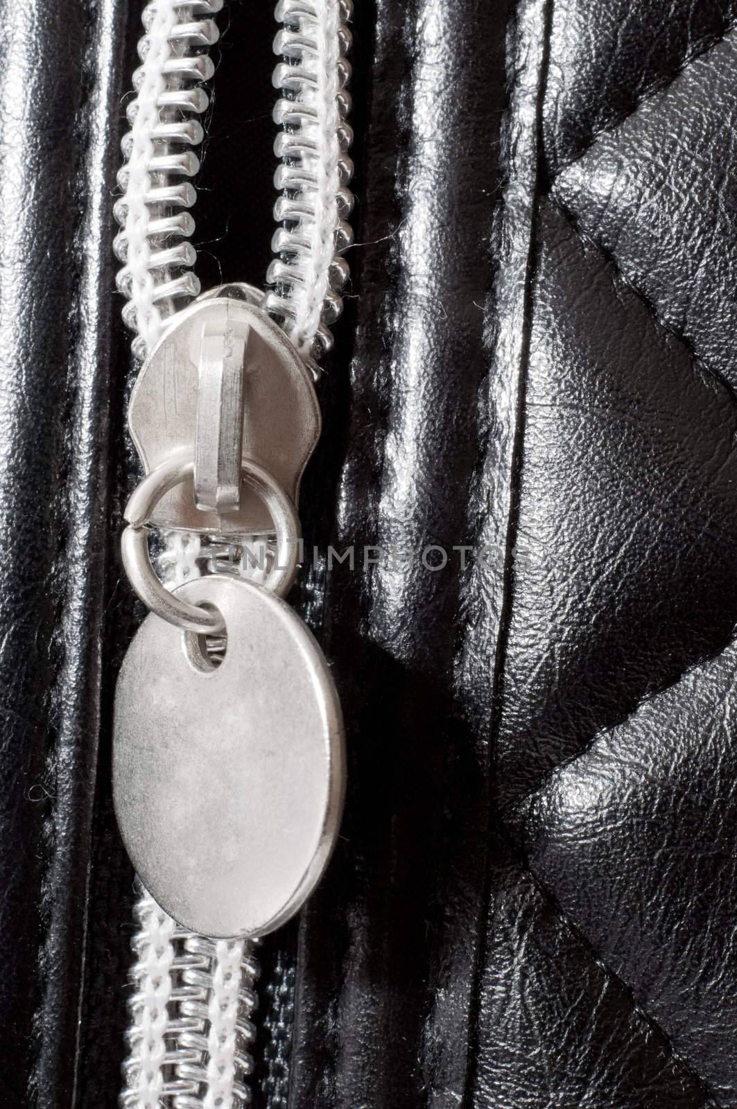 an image of zipper on black leather