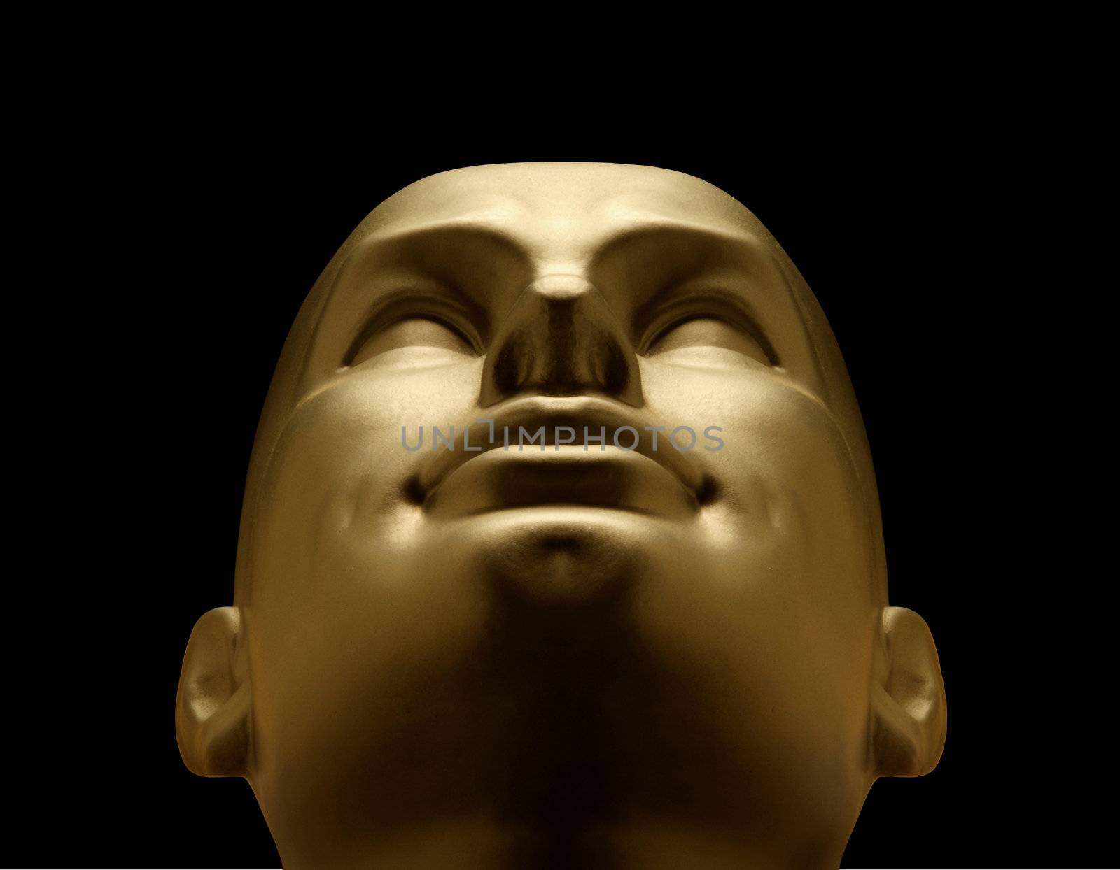 Gold mannequin head looking up against black background