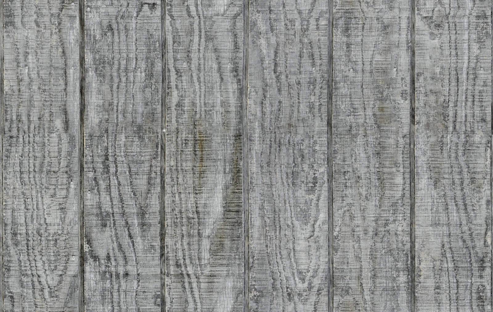 Weathered gray wooden barn siding using vertical planks