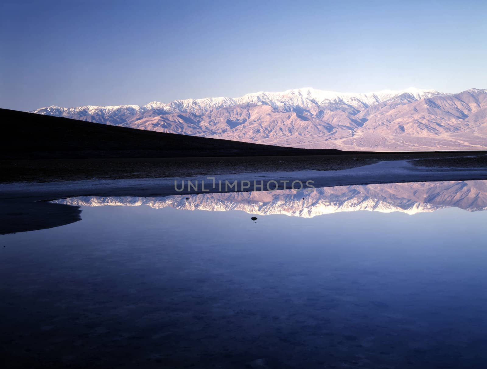 Reflection of mountain range in Badwater