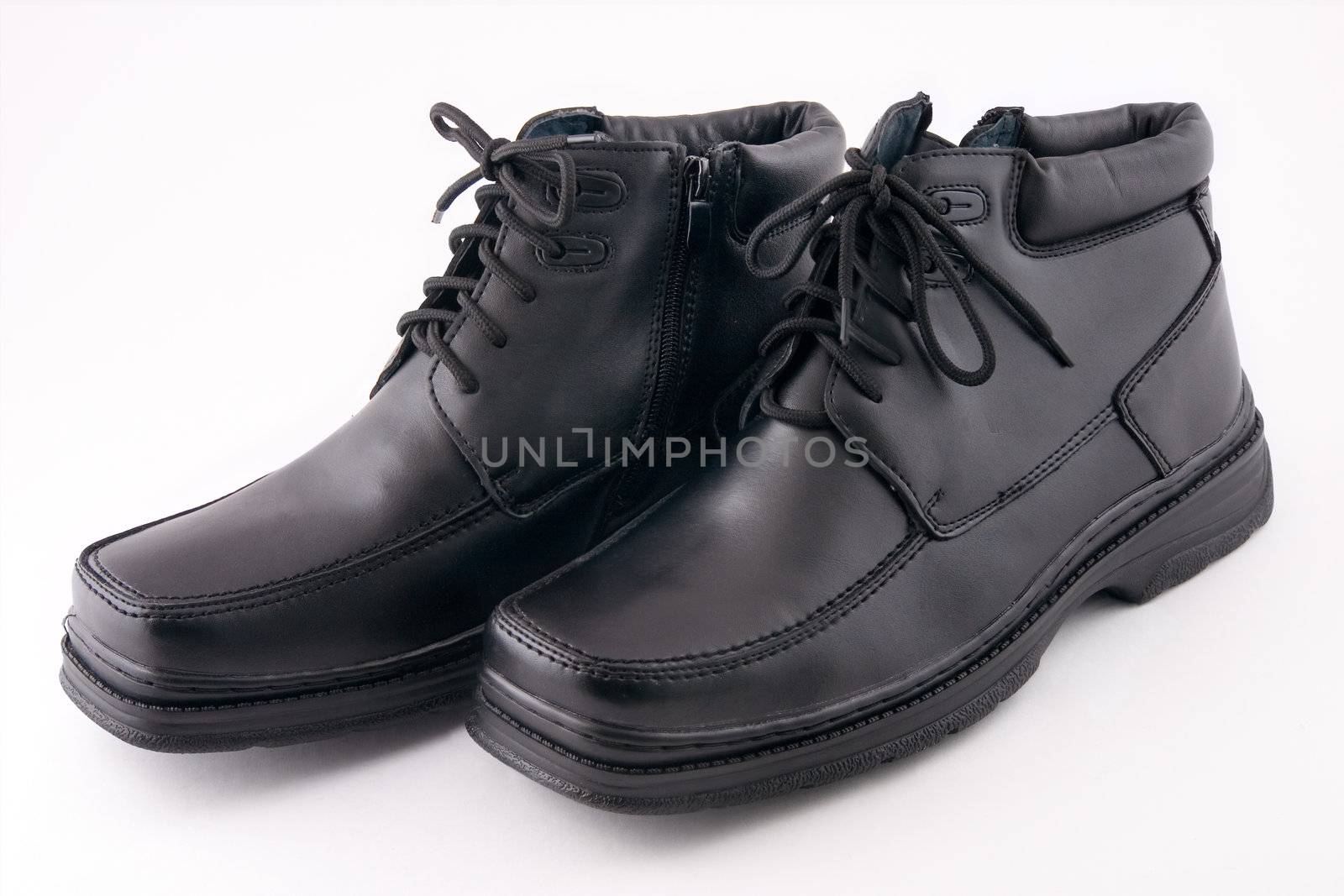 Two black boots on a white background