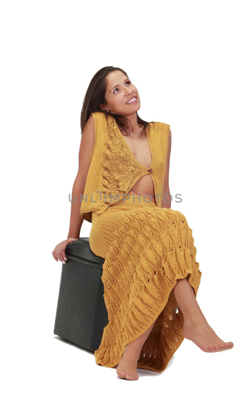 Young relaxed woman sitting on a stool,isolated against a white background.