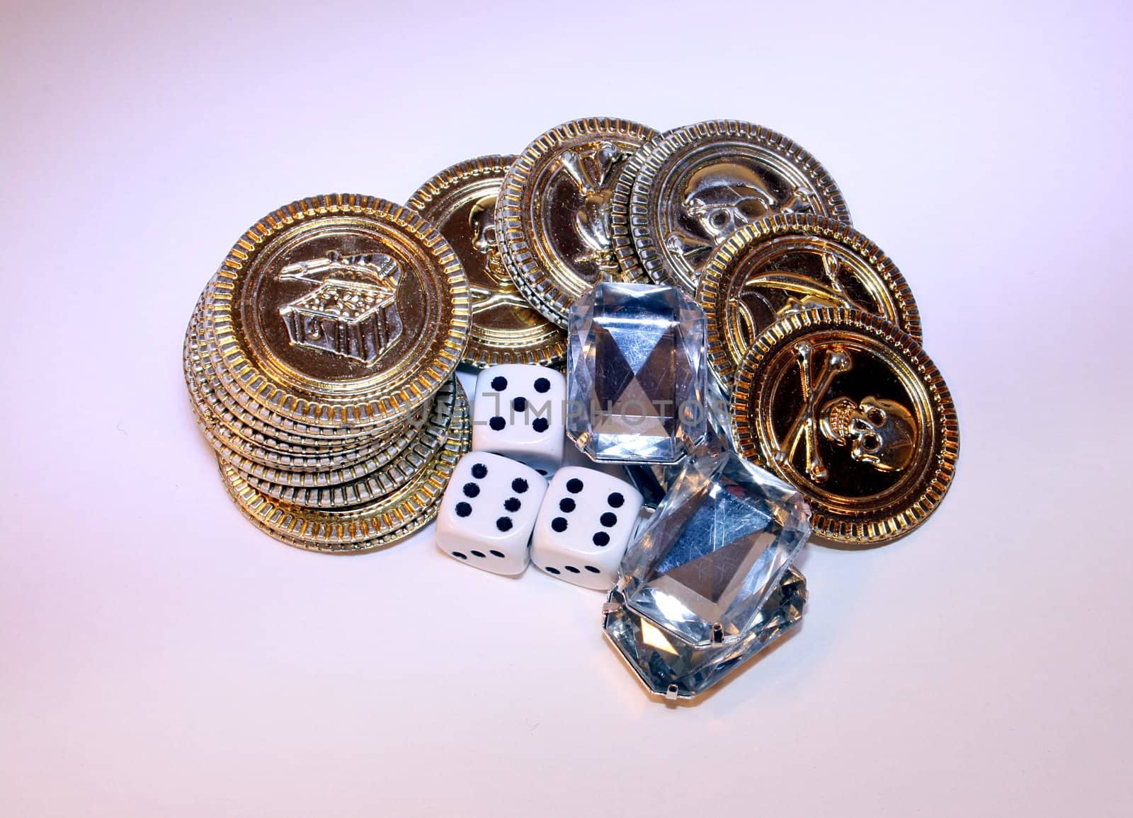 Stack of gold chips and diamonds together with dice