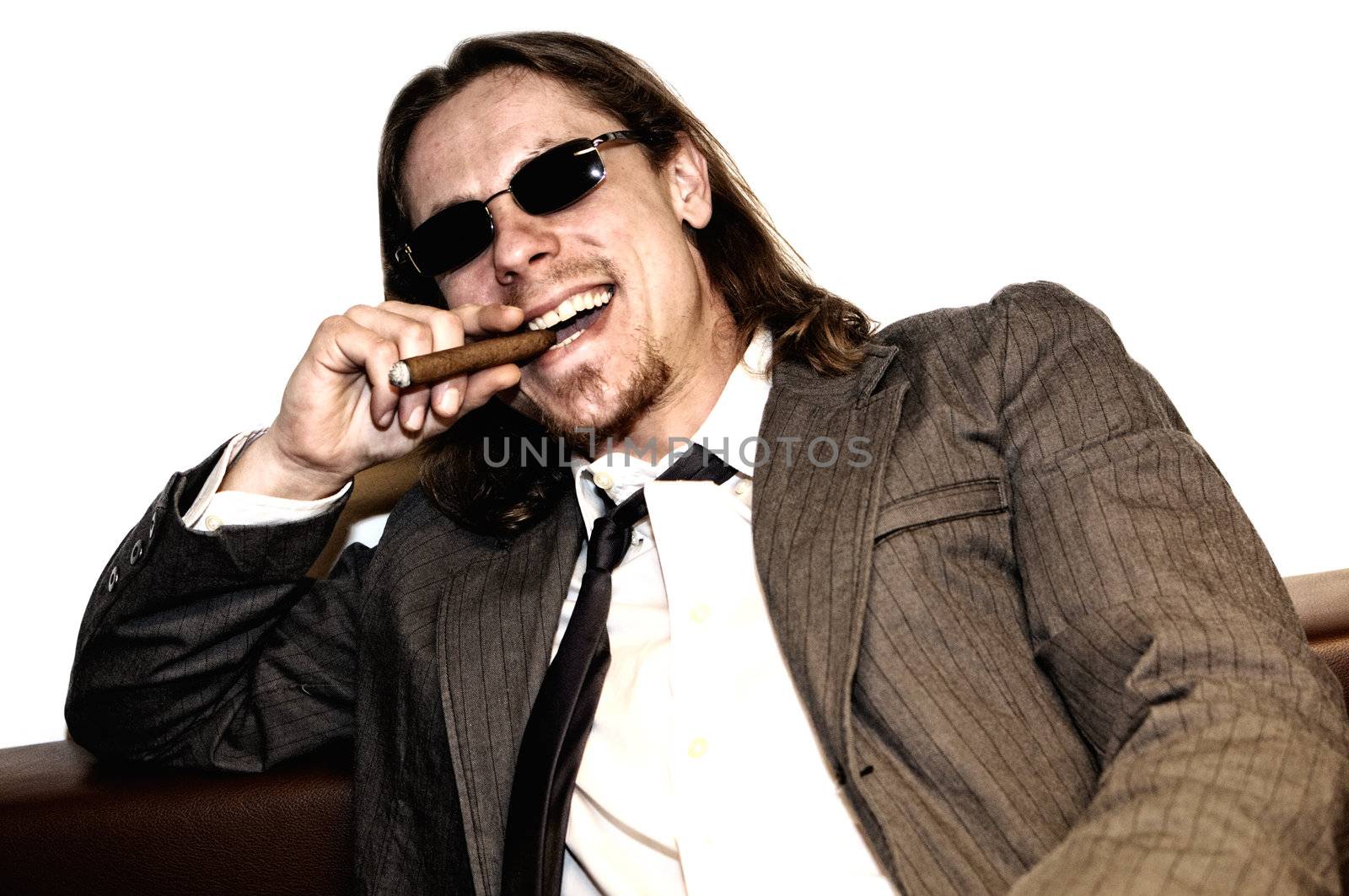 Successful businessman laughing and smoking cigar