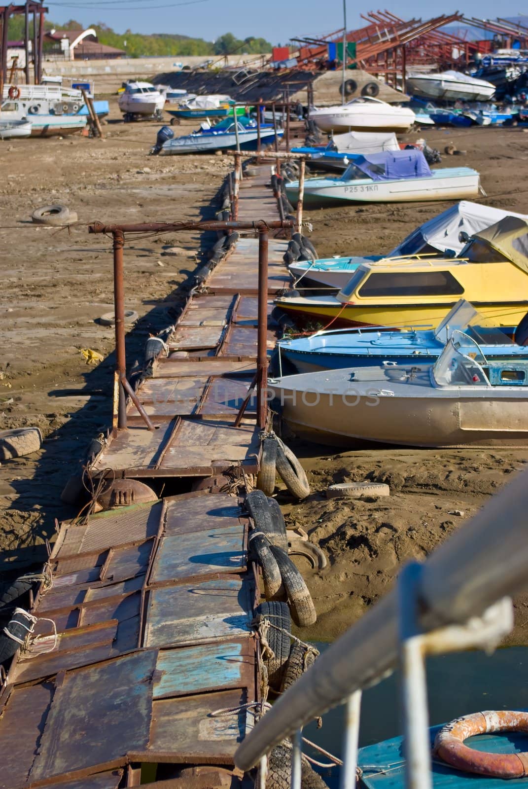 the boat marina and a boat moored near the shore