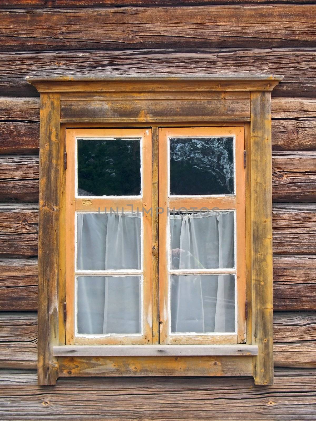 Window in old wooden wethered wall