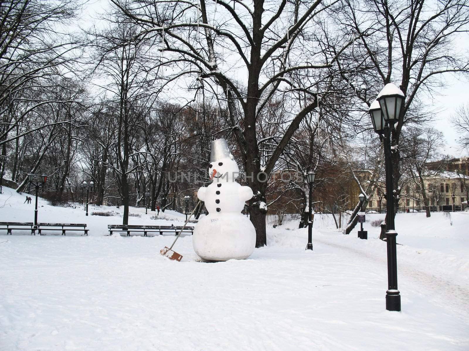 Big snowman in park in winter