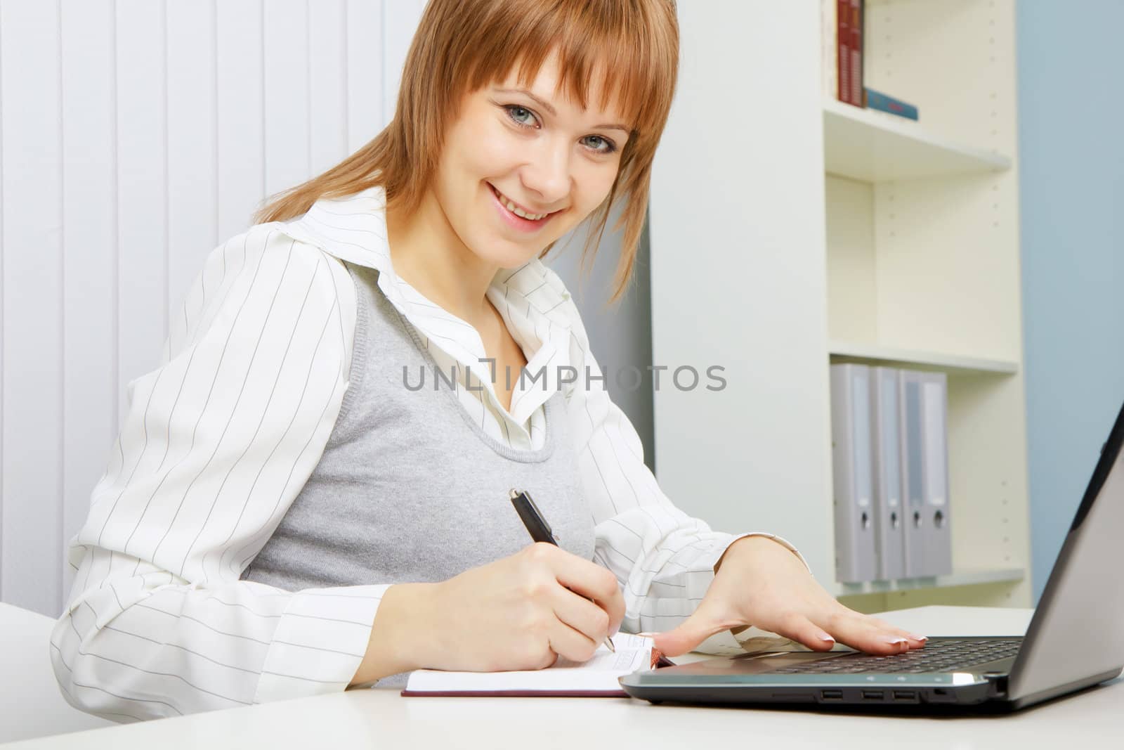 attractive young woman. Office worker with a laptop
