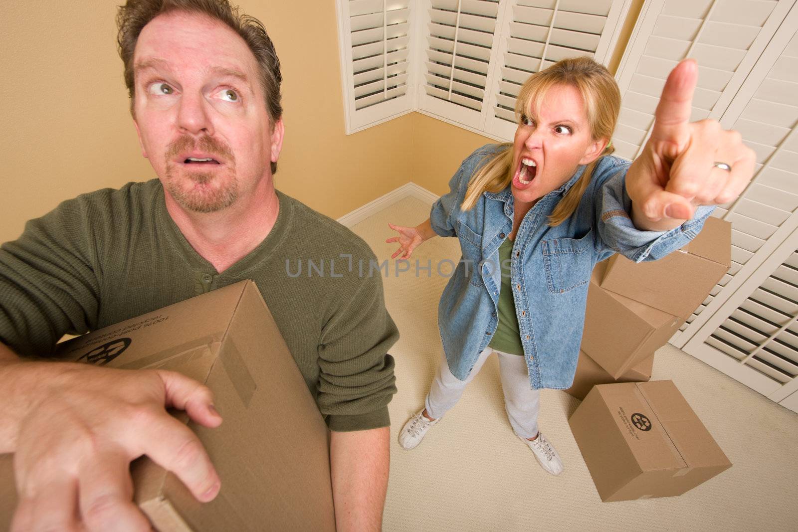 Stressed Man Moving Boxes for Demanding Wife by Feverpitched