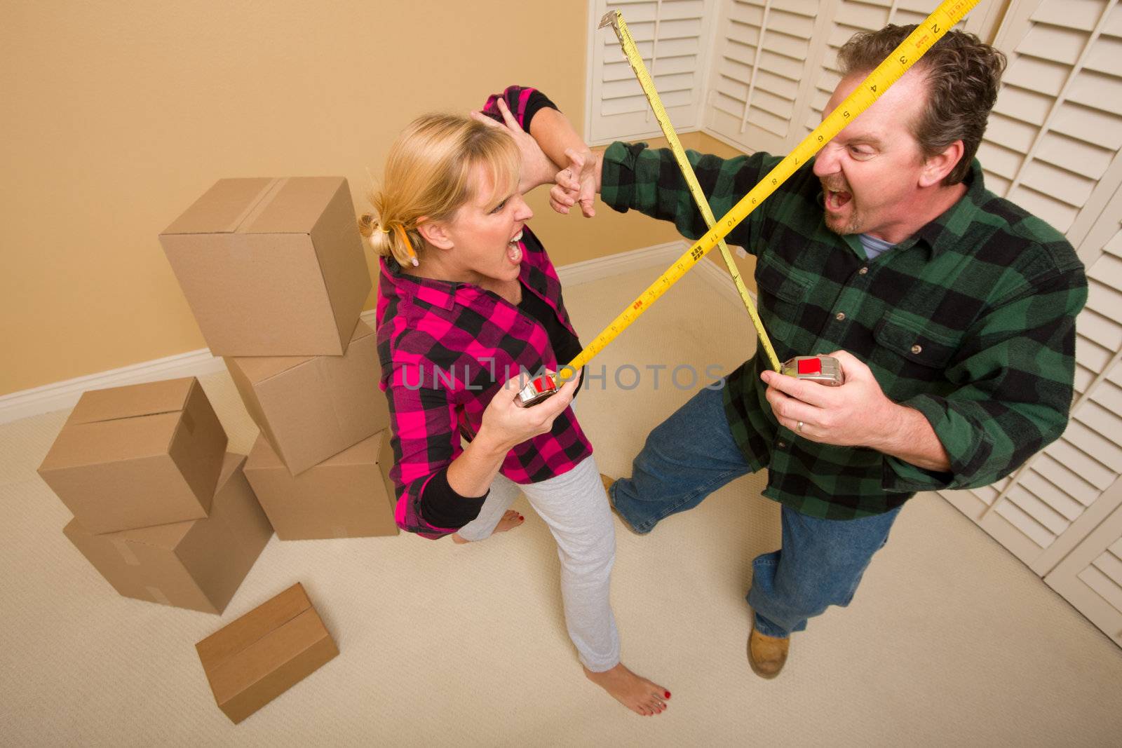 Couple Having Fun Sword Fight with Tape Measures by Feverpitched