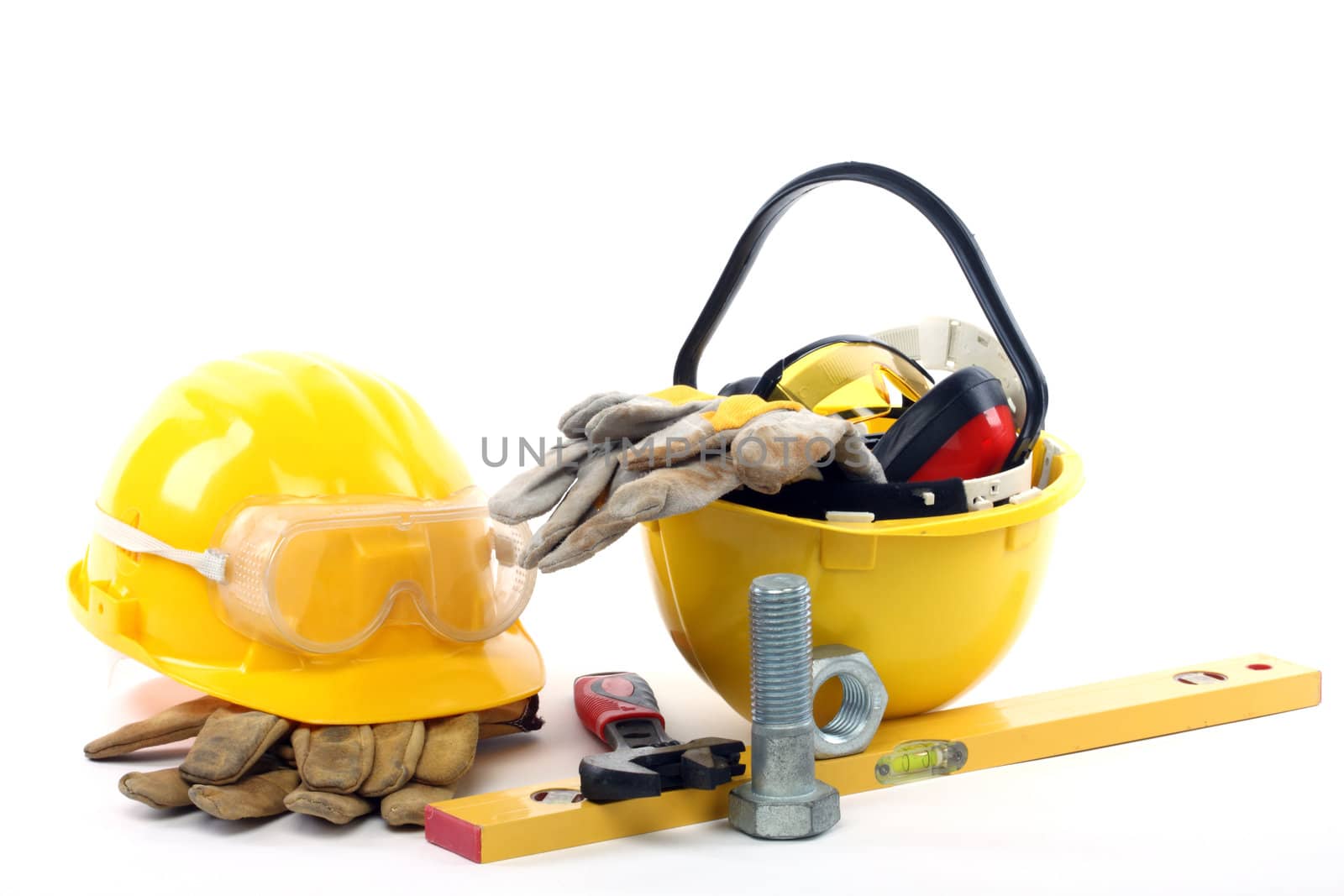 Yellow helmets and industrial tools close up