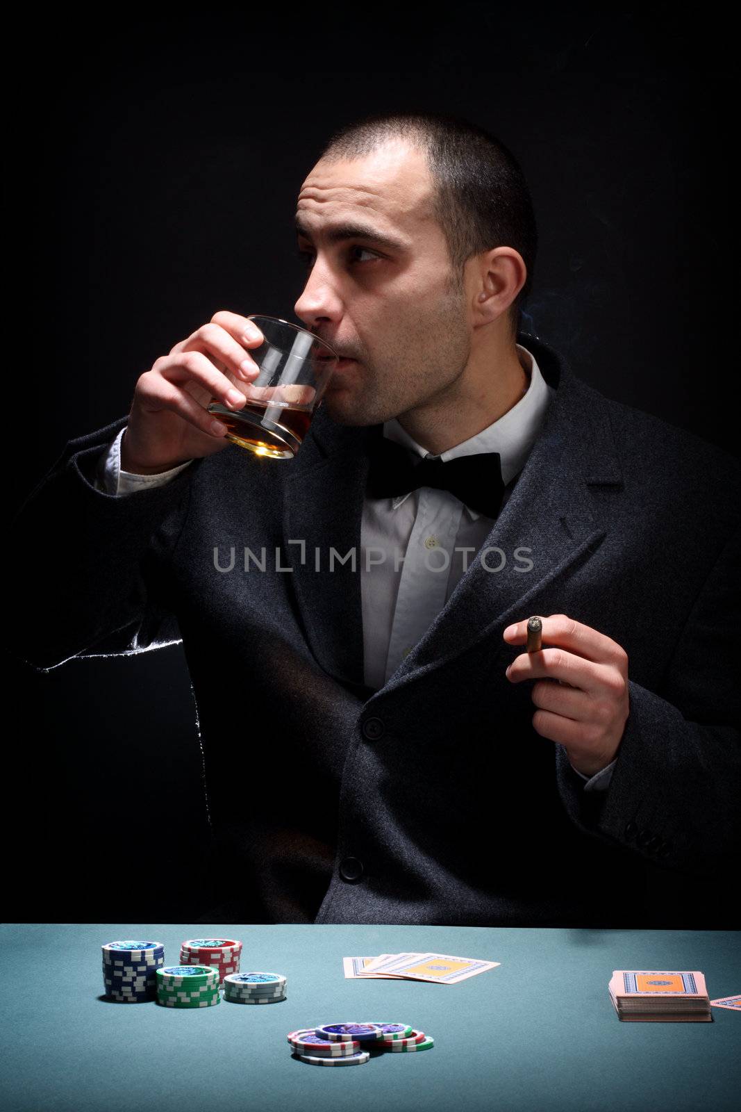 Portrait of a poker player over black background