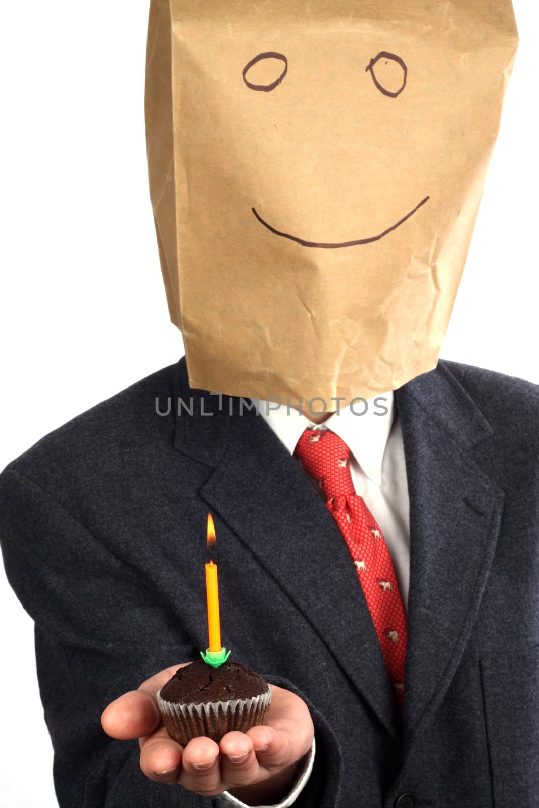 Businessman with paper bag on his head celebrating a birthday 