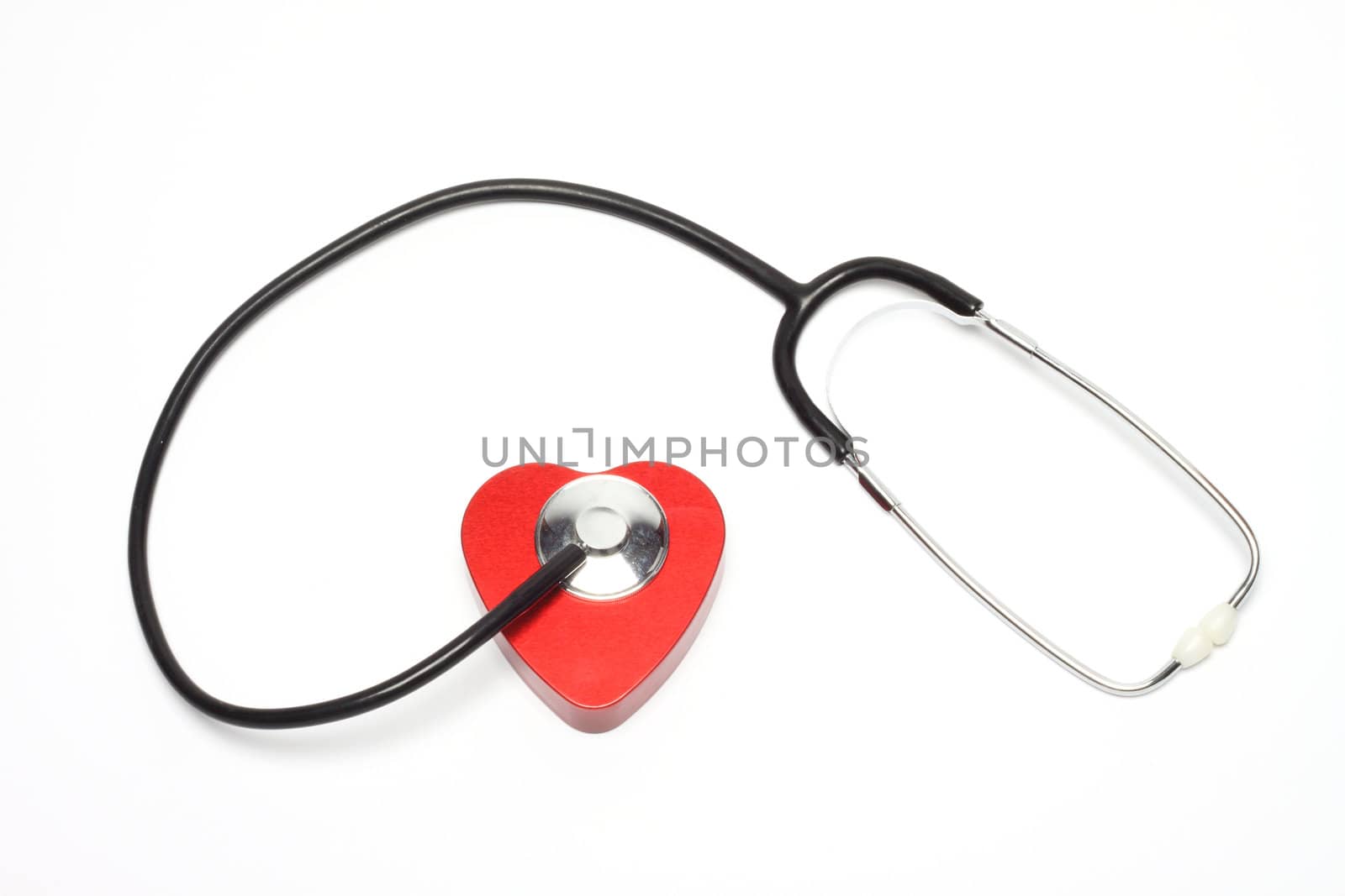 Heart and a stethoscope over in white background