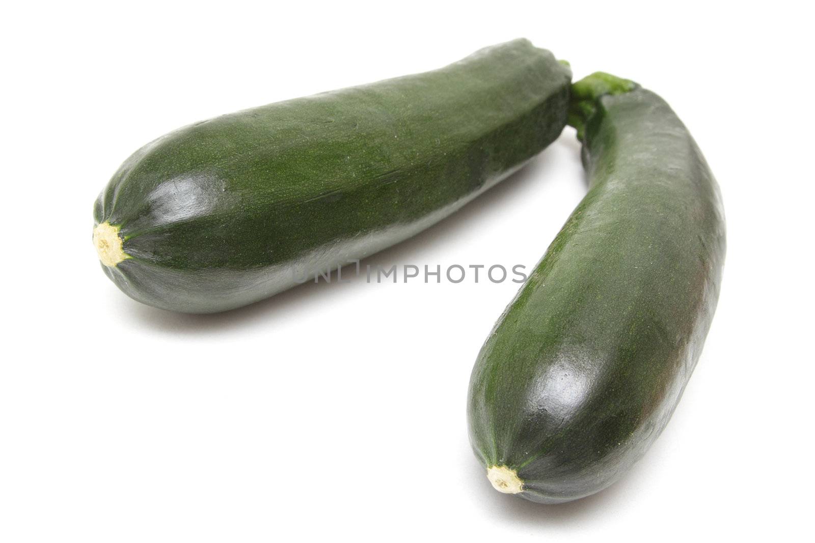 Two green zucchini isolated on white background